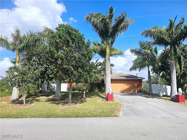 view of property hidden behind natural elements featuring a front yard