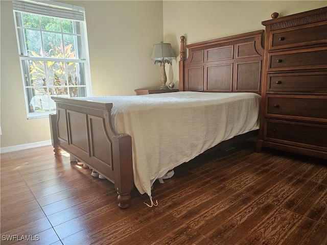 bedroom featuring dark hardwood / wood-style flooring