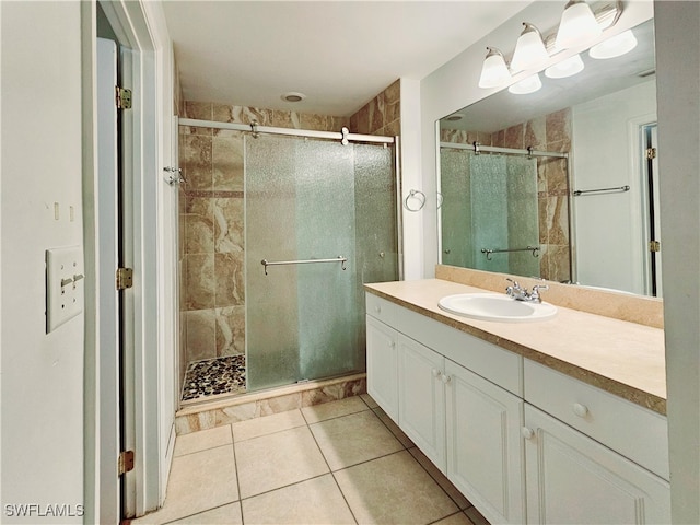 bathroom with vanity, tile patterned flooring, and a shower with shower door