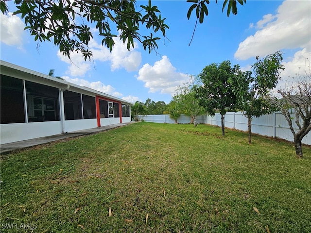 view of yard featuring a sunroom