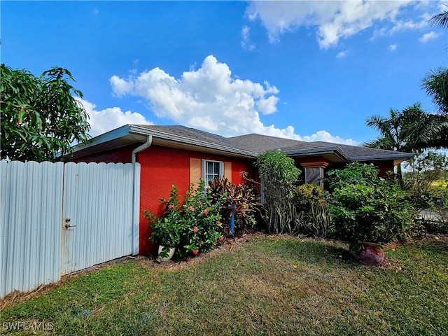 view of side of home featuring a yard