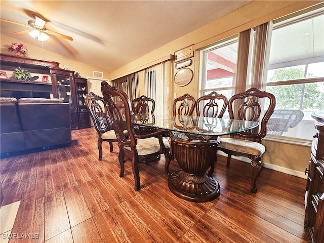 dining room with vaulted ceiling, hardwood / wood-style flooring, and ceiling fan