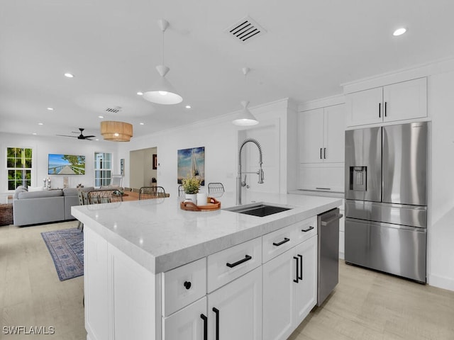 kitchen with white cabinetry, an island with sink, appliances with stainless steel finishes, and sink