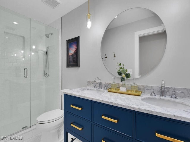 bathroom featuring vanity, an enclosed shower, and toilet