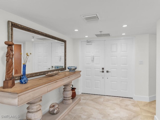 foyer featuring light tile patterned flooring