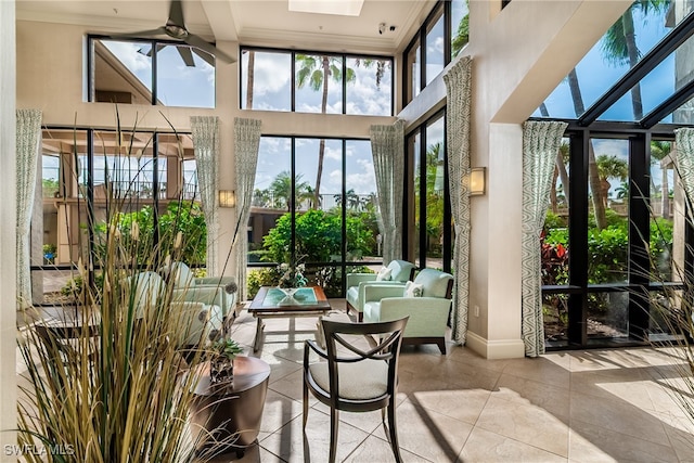 sunroom / solarium featuring ceiling fan