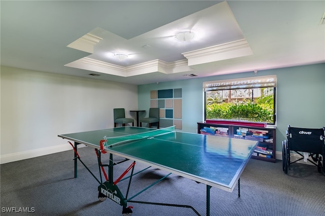 game room featuring dark colored carpet, crown molding, and a tray ceiling