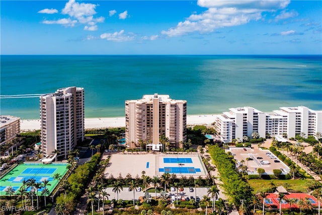 birds eye view of property with a water view and a beach view