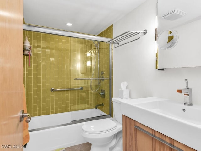 full bathroom with shower / bath combination with glass door, vanity, and toilet