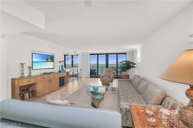 tiled living room with a wall of windows