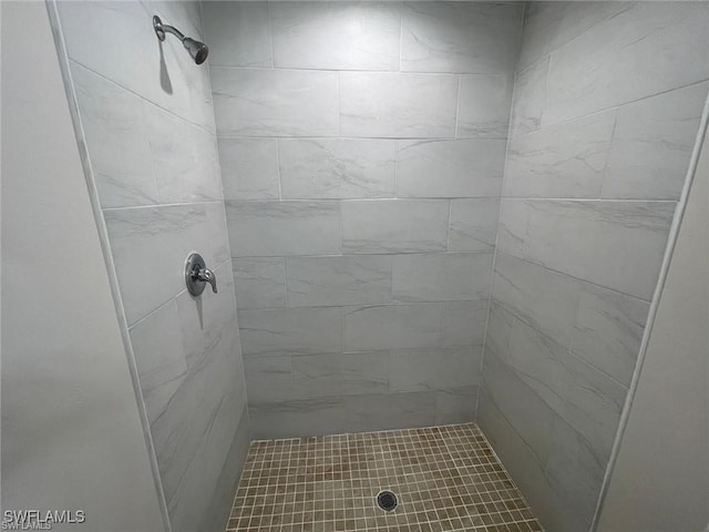 bathroom with a tile shower