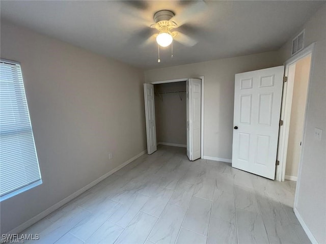 unfurnished bedroom with ceiling fan and a closet