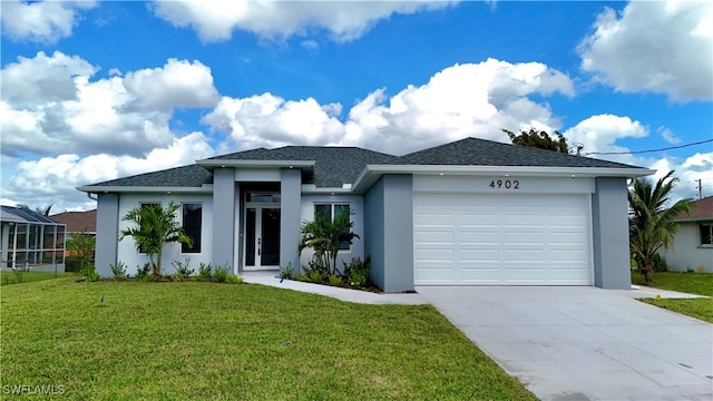 view of front of property with a front yard and a garage