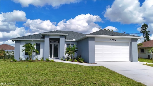 view of front of property featuring a garage and a front lawn