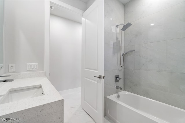 bathroom with vanity and tiled shower / bath combo