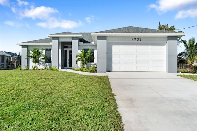 view of front facade with a garage and a front lawn