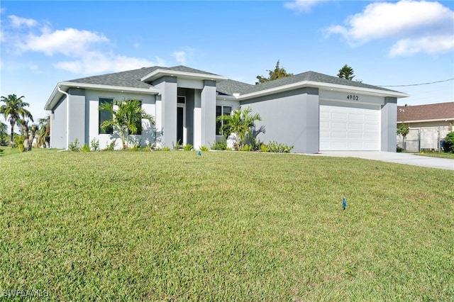 view of front of property with a garage and a front lawn