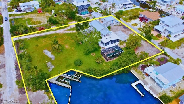 birds eye view of property featuring a water view and a residential view