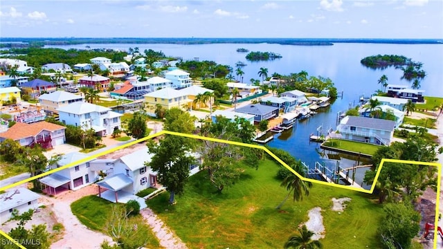 drone / aerial view with a residential view and a water view