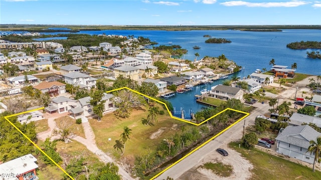 drone / aerial view featuring a residential view and a water view