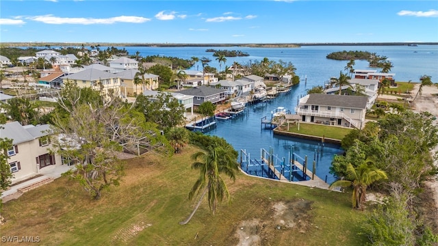 birds eye view of property with a water view and a residential view