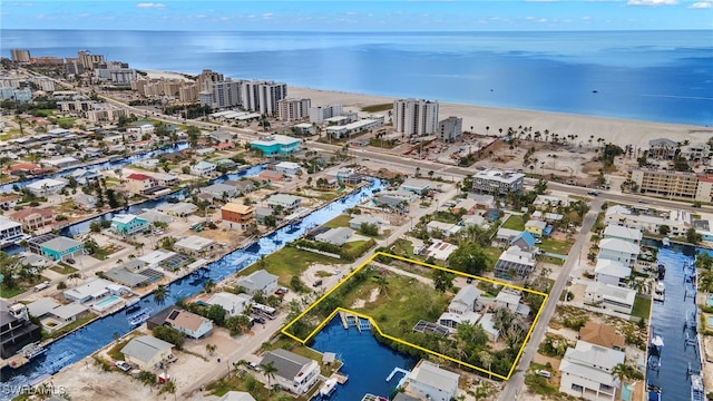 aerial view featuring a water view, a view of the beach, and a city view