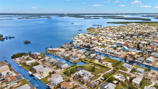 birds eye view of property with a water view and a residential view