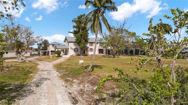 view of front facade featuring dirt driveway and a residential view