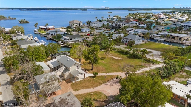 drone / aerial view featuring a water view and a residential view