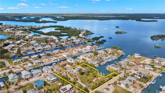 drone / aerial view featuring a water view and a residential view