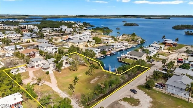 drone / aerial view with a water view and a residential view