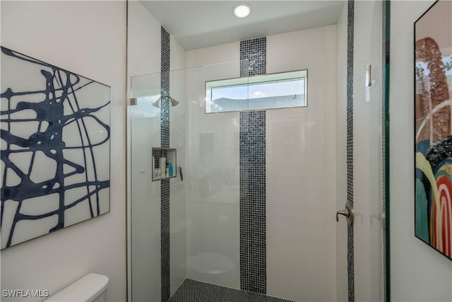 full bathroom with a stall shower and toilet