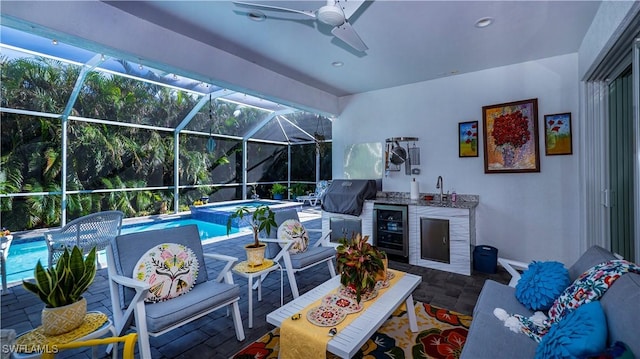 view of pool with ceiling fan, a pool with connected hot tub, and grilling area