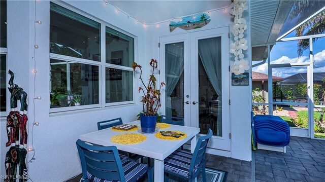 view of patio / terrace featuring french doors and glass enclosure