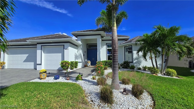 view of front of home featuring a garage and a front lawn