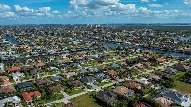 aerial view featuring a water view and a residential view