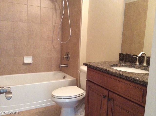 full bathroom featuring tile patterned flooring, tiled shower / bath, toilet, and vanity