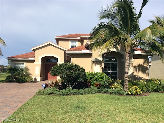 291 Saddlebrook Ln, Naples, FL 34110 - mediterranean / spanish-style home featuring stucco siding, a front lawn, and a tile roof