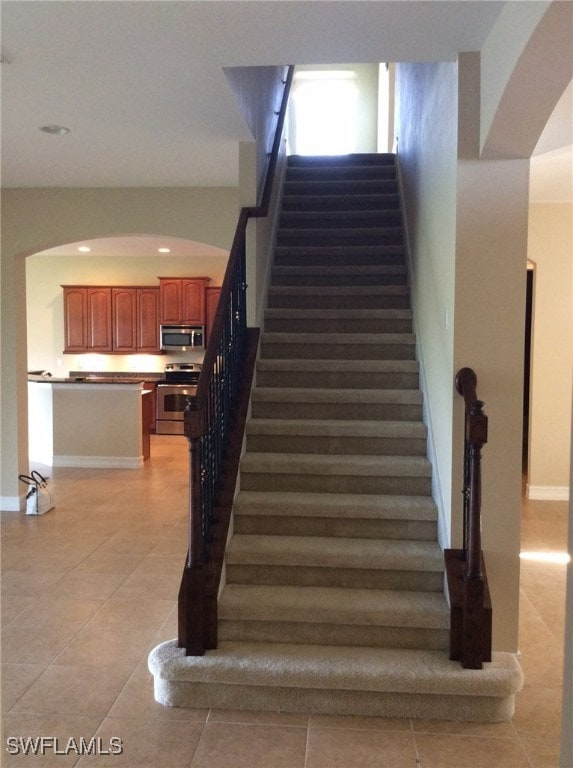 staircase with tile patterned flooring