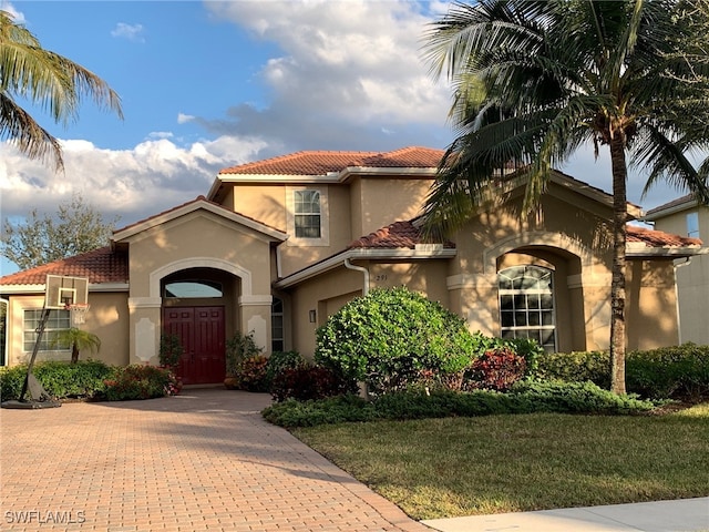 mediterranean / spanish-style house featuring a front yard