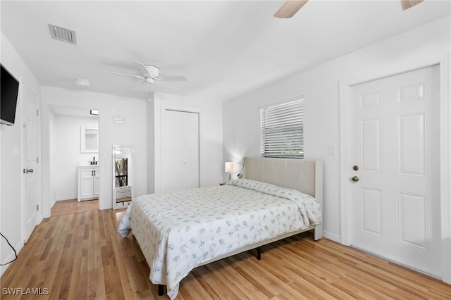 bedroom with light wood-style floors, baseboards, a closet, and ceiling fan