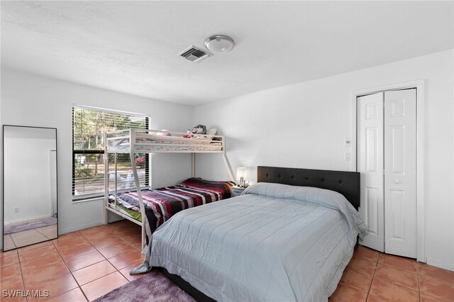 tiled bedroom featuring baseboards