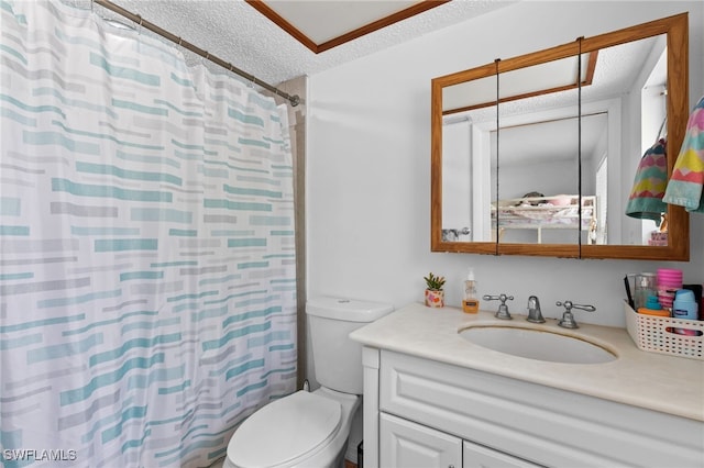 bathroom with a textured ceiling, toilet, vanity, and a shower with curtain