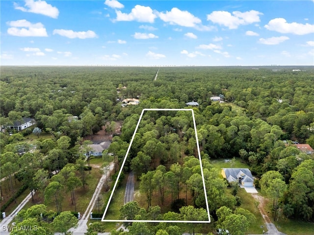 view of property location featuring a heavily wooded area and property parcel outlined