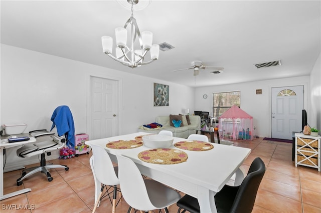 dining room featuring light tile patterned flooring and ceiling fan with notable chandelier