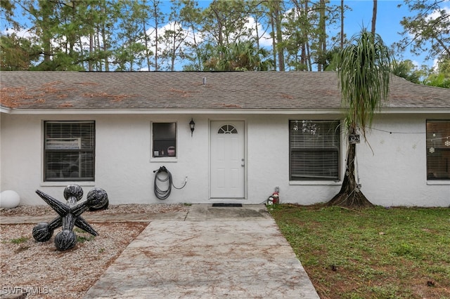 view of front of house featuring a front lawn and a patio