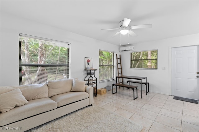 living room featuring a ceiling fan, light tile patterned floors, a wall unit AC, and baseboards