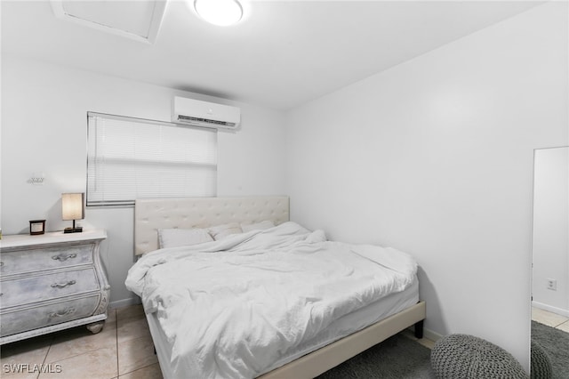 bedroom featuring light tile patterned floors and a wall mounted air conditioner