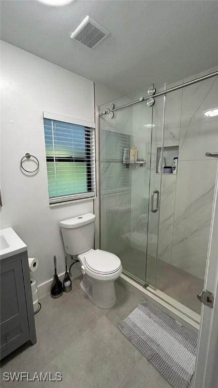 full bath featuring toilet, a stall shower, vanity, and concrete floors