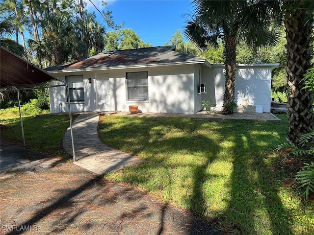 ranch-style house with stucco siding and a front yard
